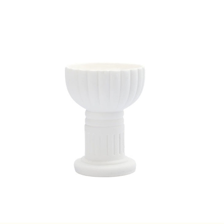White ceramic candle cup with vertical striped design, for holding tealights or votive candles.