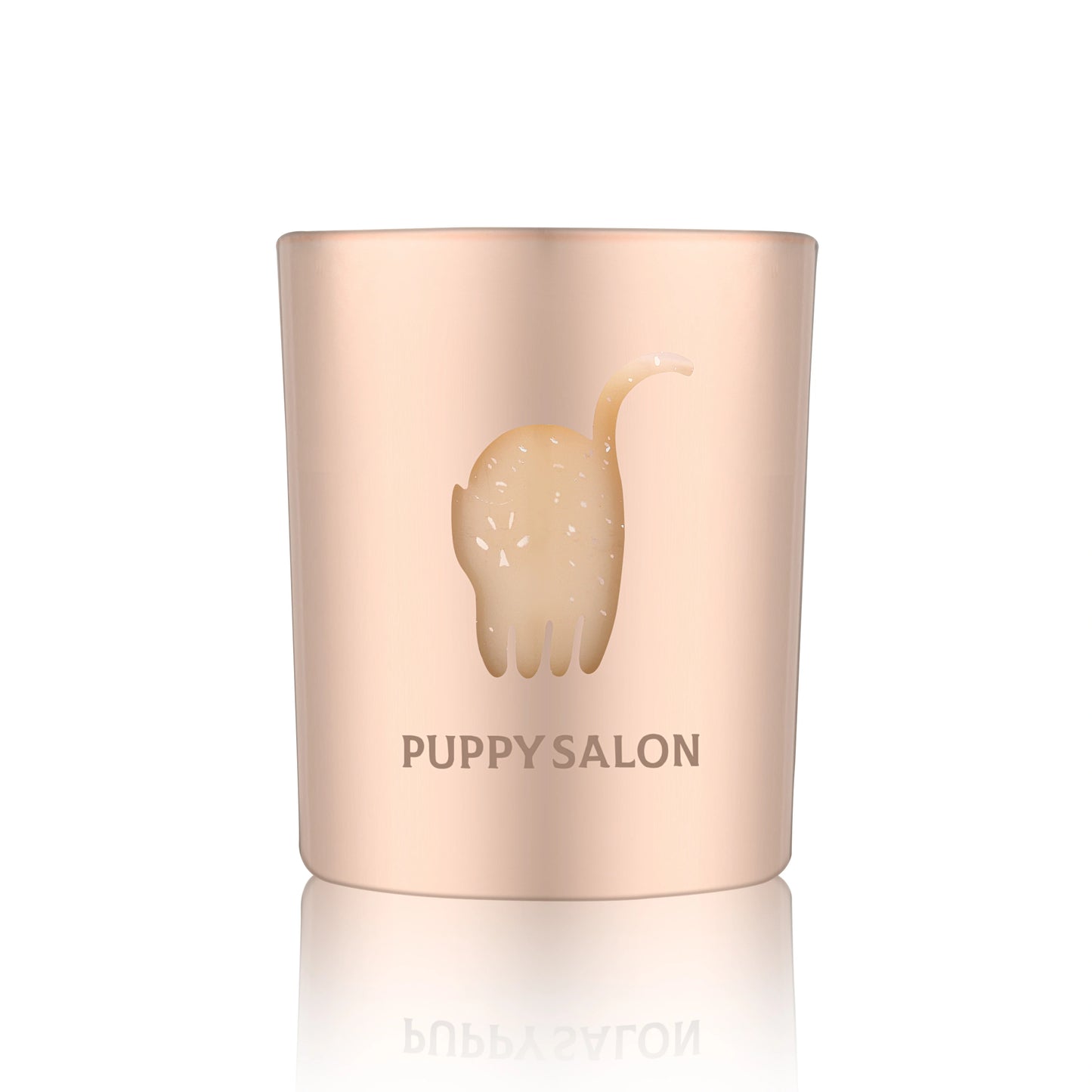 Isolated view of the Puppy Salon cat-inspired candle. The rose gold cut-out glass jar creates a warm, glowing pattern when lit.