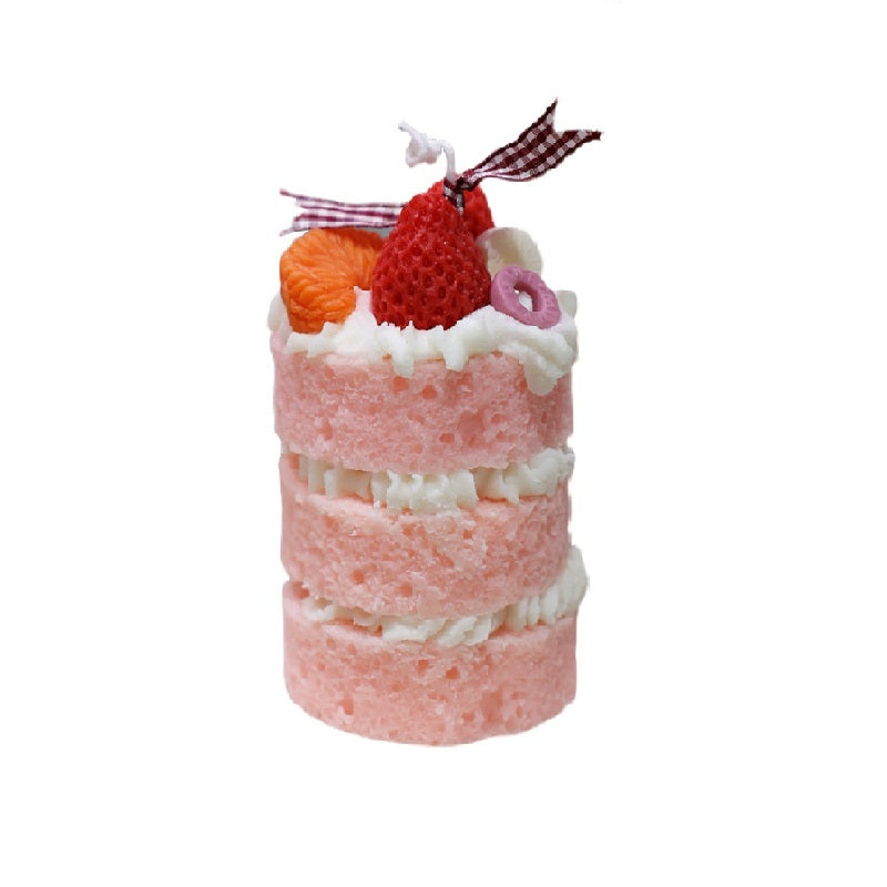 A realistic strawberry cake shaped scented candle. A decorative and fragrant home decor item or unique gift idea.