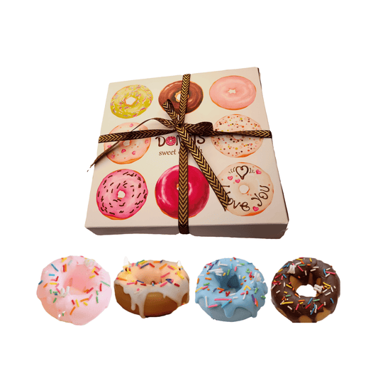 Product shot of the 4-pack donut-shaped scented candle set, presented with a gift box. Contains assorted designs for birthdays and parties.