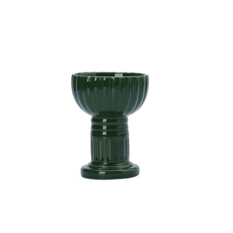 Green ceramic candle cup with vertical striped design, for holding tealights or votive candles.