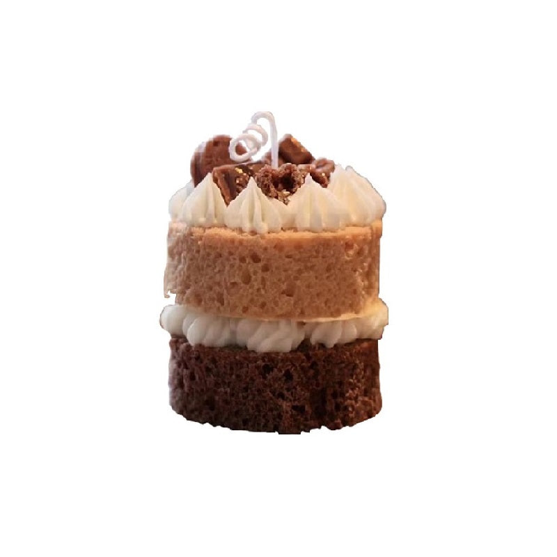 Isolated view of a realistic chocolate cake shaped scented candle. A decorative and fragrant home decor item or unique gift idea.