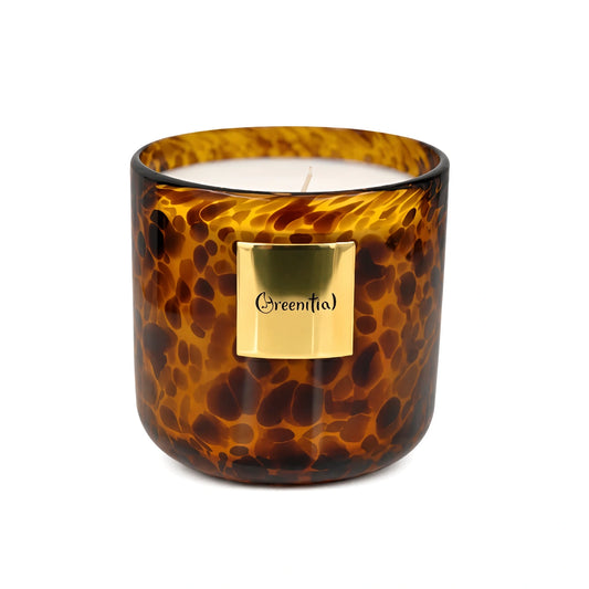 Luxury leopard print scented candle glowing in a cozy New York apartment at night as a fashionable woman enjoys a relaxing self-care evening with wine, soft lighting, and cinematic luxury vibes.