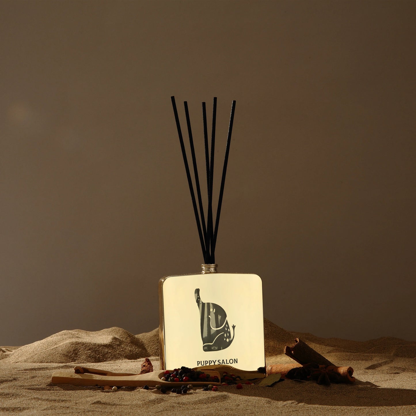 Lifestyle image of the Puppy Salon 'Journey of the Elephants' reed diffuser in a desert-inspired setting, evoking the spicy, exotic fragrance journey of the scent.