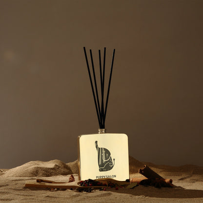 Lifestyle image of the Puppy Salon 'Journey of the Elephants' reed diffuser in a desert-inspired setting, evoking the spicy, exotic fragrance journey of the scent.