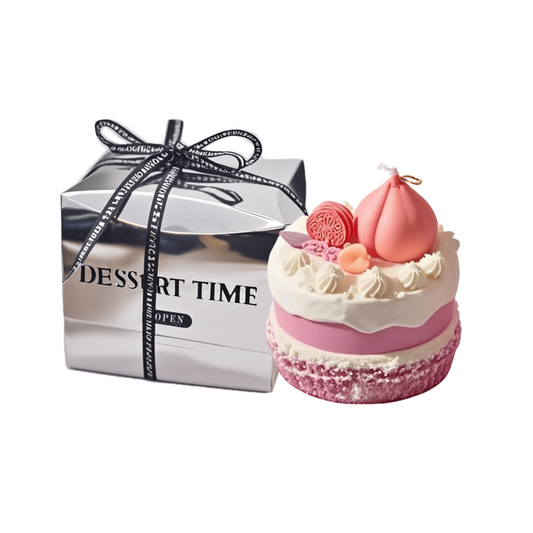 A realistic peach cake shaped scented candle with silver packaging box. A decorative and fragrant home decor item or unique gift idea.