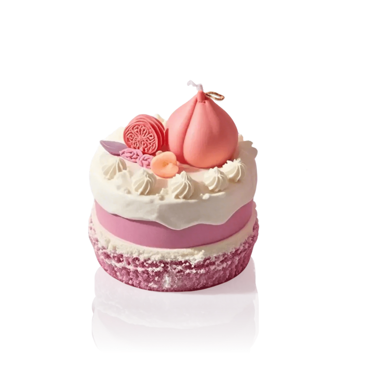 Isolated view of a realistic peach cake shaped scented candle. A decorative and fragrant home decor item or unique gift idea.