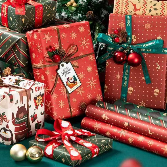 A beautifully wrapped gift box using the red and gold snowflake holiday paper, showing the final presentation.