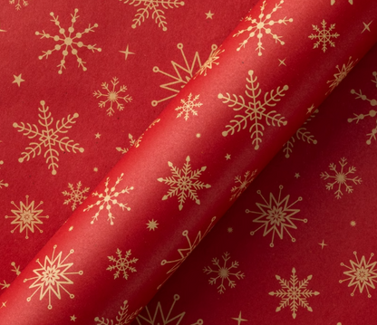 Holiday wrapping paper with a red background and elegant gold snowflake patterns, perfect for Christmas gifts.
