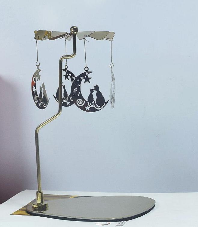 Gold metal rotary candle holder with a cat design. Uses heat from candles to spin and create dynamic shadows.