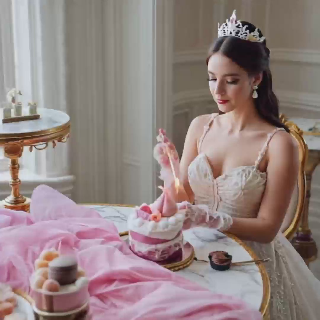 An elegant afternoon tea scene featuring a woman lighting and enjoying the realistic peach cake shaped scented candle, showcasing its use in creating a sophisticated atmosphere.