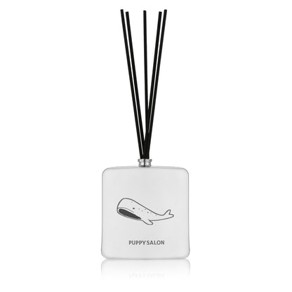 Isolated view of the Puppy Salon '52 Hertz' reed diffuser. The sleek silver glass bottle with abstract cut-outs creates a mysterious, modern ambiance.