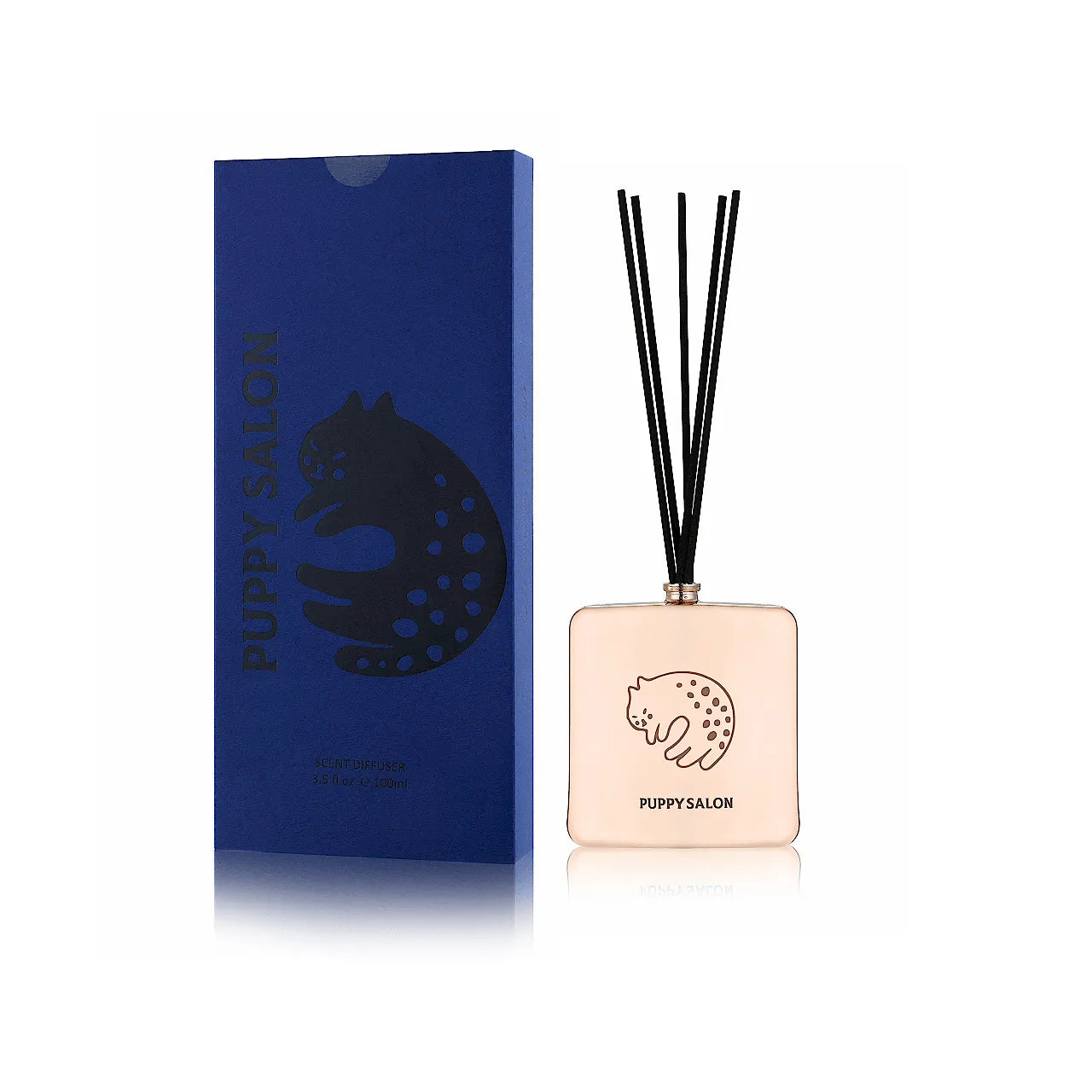 The Puppy Salon cat-inspired reed diffuser with its elegant blue gift box. Features a rose gold cut-out glass vessel for stylish living room decor.