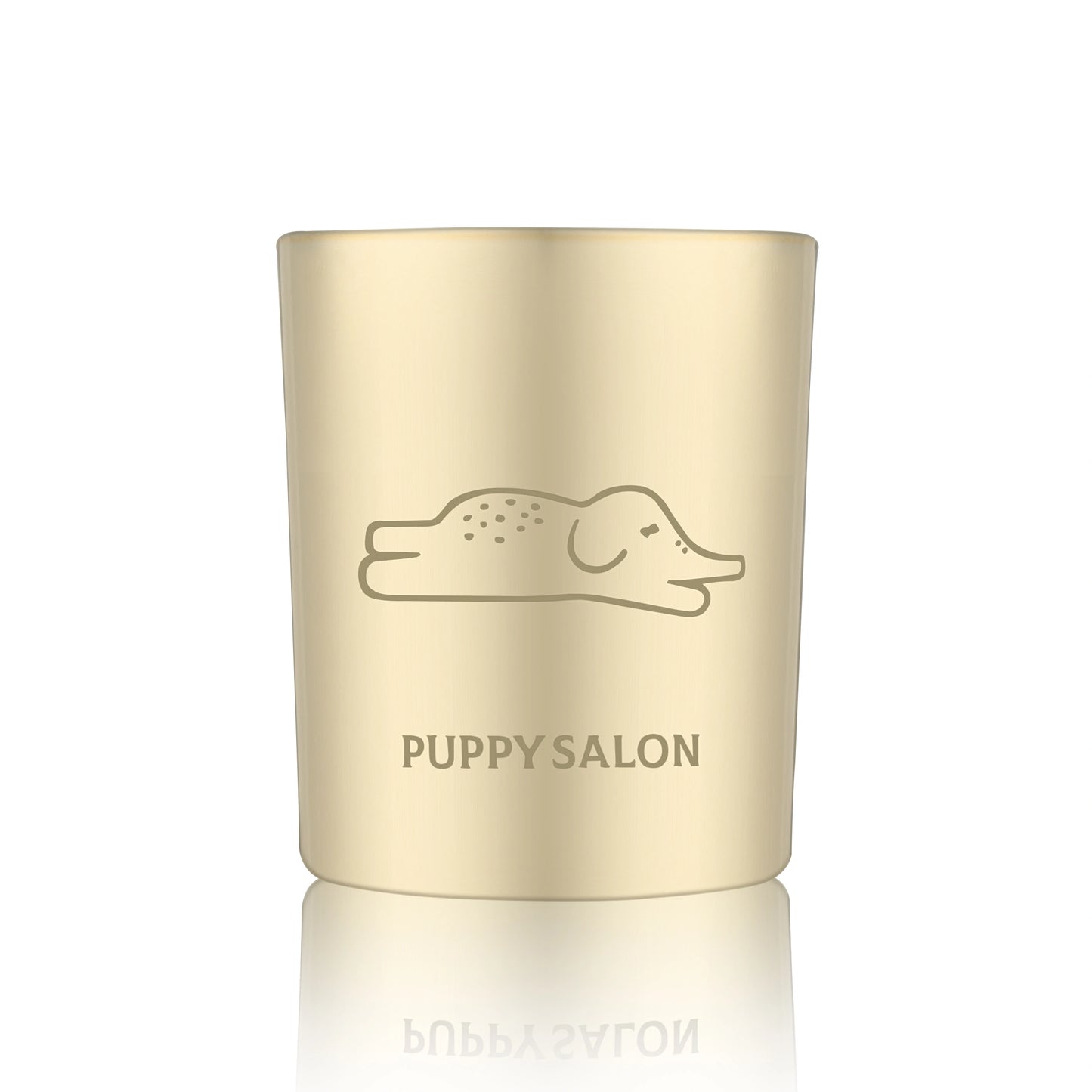 Isolated view of the Puppy Salon 'An Elephant Never Forgets' candle. The gold cut-out glass jar creates a warm, glowing pattern when lit.