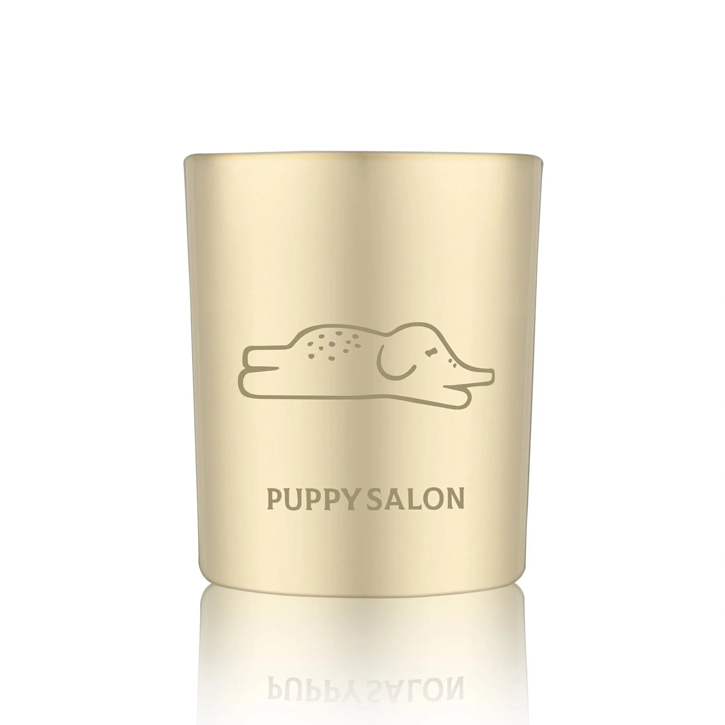 Isolated view of the Puppy Salon 'An Elephant Never Forgets' candle. The gold cut-out glass jar creates a warm, glowing pattern when lit.